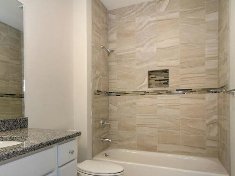 Gray tile with linear mosaic accent and niche
