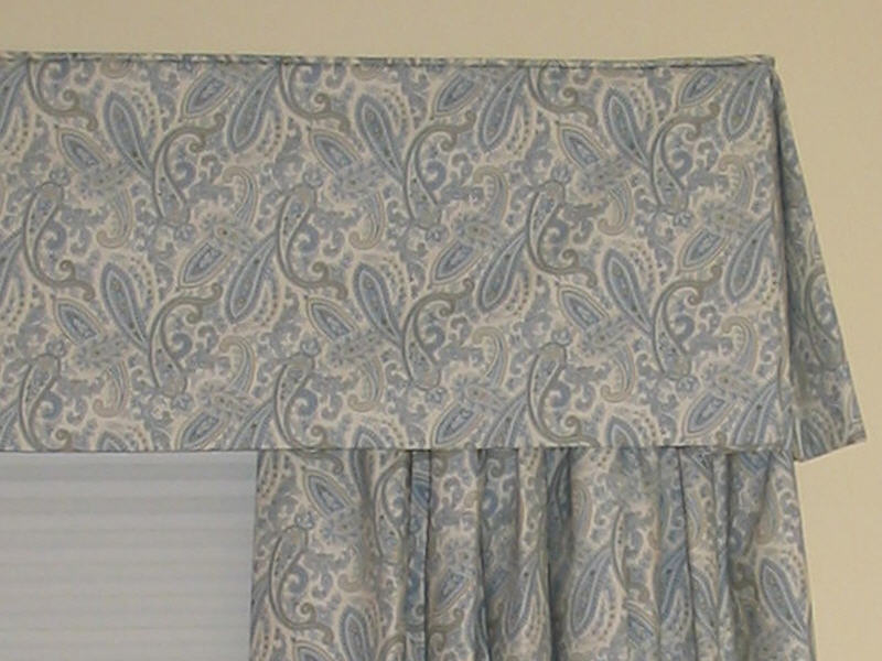 Box pleated valance with matching side panels in a soft blue and cream paisley 